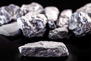 Manganese, manganese or magnesium stone is a chemical element, it is in the manufacture of metal alloys. Silver colored ore, industrial use. Ore on black isolated background.